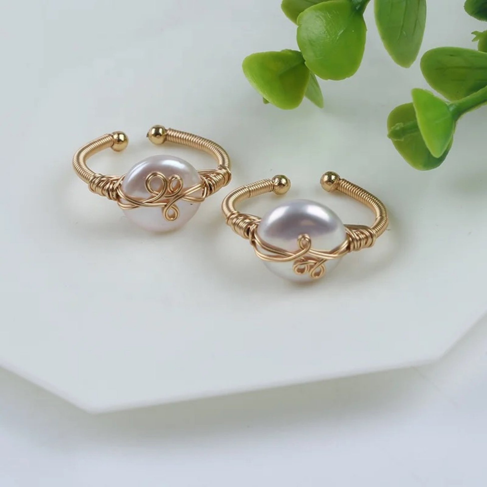 Close up of the Smooth freshwater pearl ring with a sleek 18K gold-plated band and textured gold accent, offering artisanal elegance.