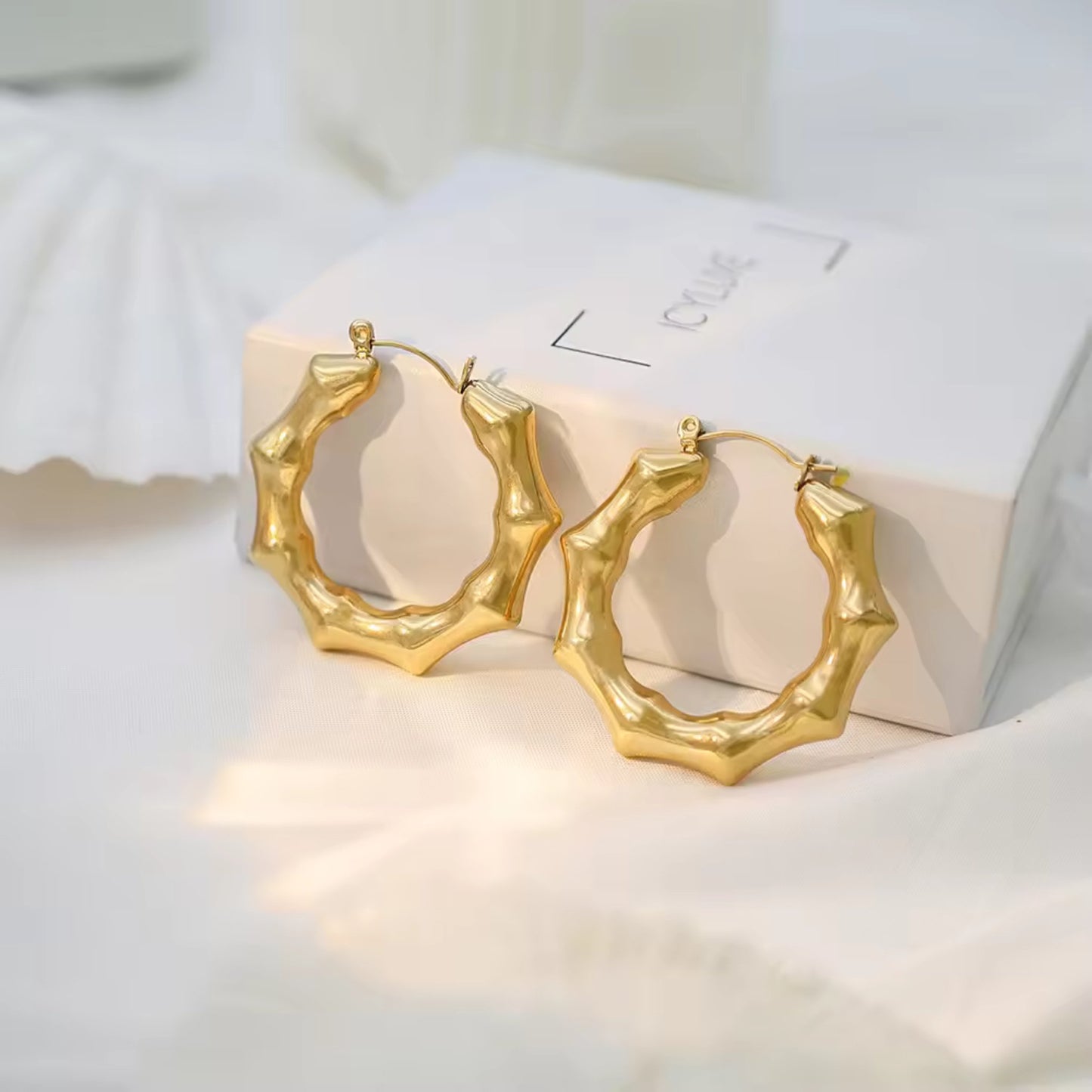 Bamboo Twist Hoop Earrings crafted from stainless steel and 18K gold plating, featuring a hollow bamboo-inspired design.