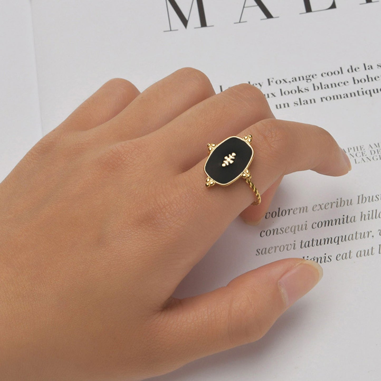 Black Onyx Adjustable Gold Plated Ring featuring a bold black onyx stone and intricate gold-plated detailing, styled on a model's hand for an elegant look