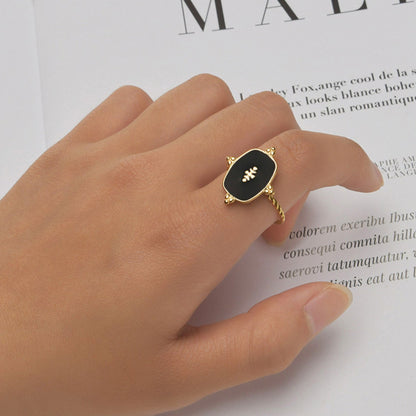 Black Onyx Adjustable Gold Plated Ring featuring a bold black onyx stone and intricate gold-plated detailing, styled on a model's hand for an elegant look