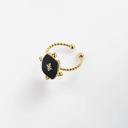 Close up of the Black Onyx Adjustable Gold Plated Ring with a 1.5 cm x 1.2 cm black onyx stone and a twisted gold-plated band, showcasing its timeless elegance.