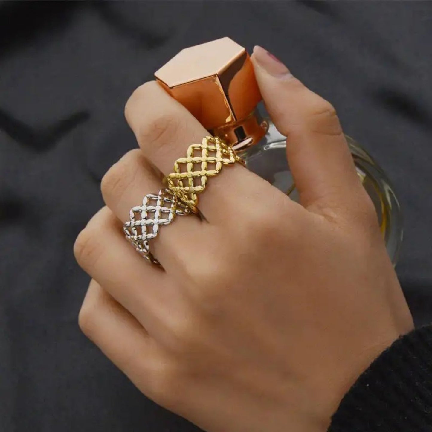Golden Bloom Filigree Adjustable Ring featuring an intricate floral filigree design with 18K gold plating, styled on a model's hand for an elegant look.