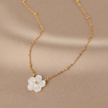 Close-up of the Blossom Beauty Necklace showcasing the lustrous mother of pearl flower pendant with a golden center.