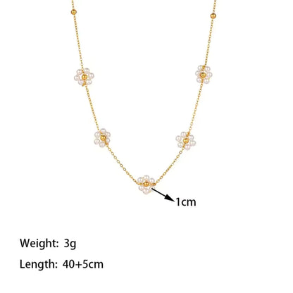 Details of the Close-up of Blossom Elegance Pearl Necklace featuring intricately designed floral accents with lustrous pearls in an 18K gold-plated finish.