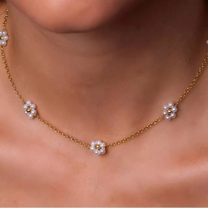 Blossom Elegance Pearl Necklace with floral accents and pearls, styled on a model for a graceful and sophisticated look.