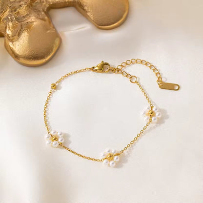 Close-up of Blossom Elegance Pearl Bracelet featuring intricately designed floral accents with lustrous pearls in an 18K gold-plated finish.