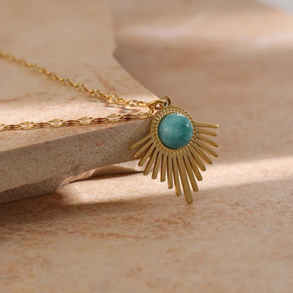 Close up of the Bohemian Radiance Necklace with a radiant 18K gold-plated pendant and natural turquoise stone, offering summer bohemian elegance.