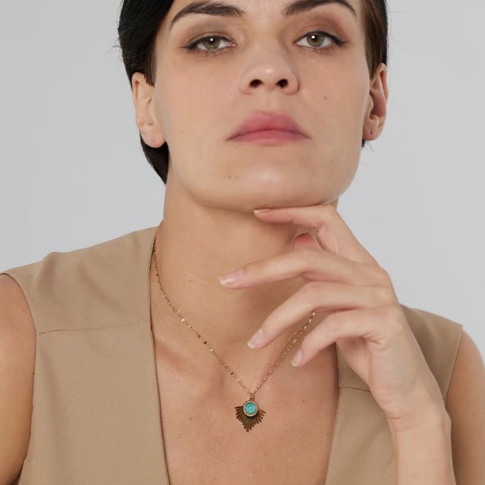 Radiating pendant necklace from the Bohemian Radiance Turquoise Jewelry Set, styled on a model to showcase its vibrant turquoise stone and 18K gold plating.