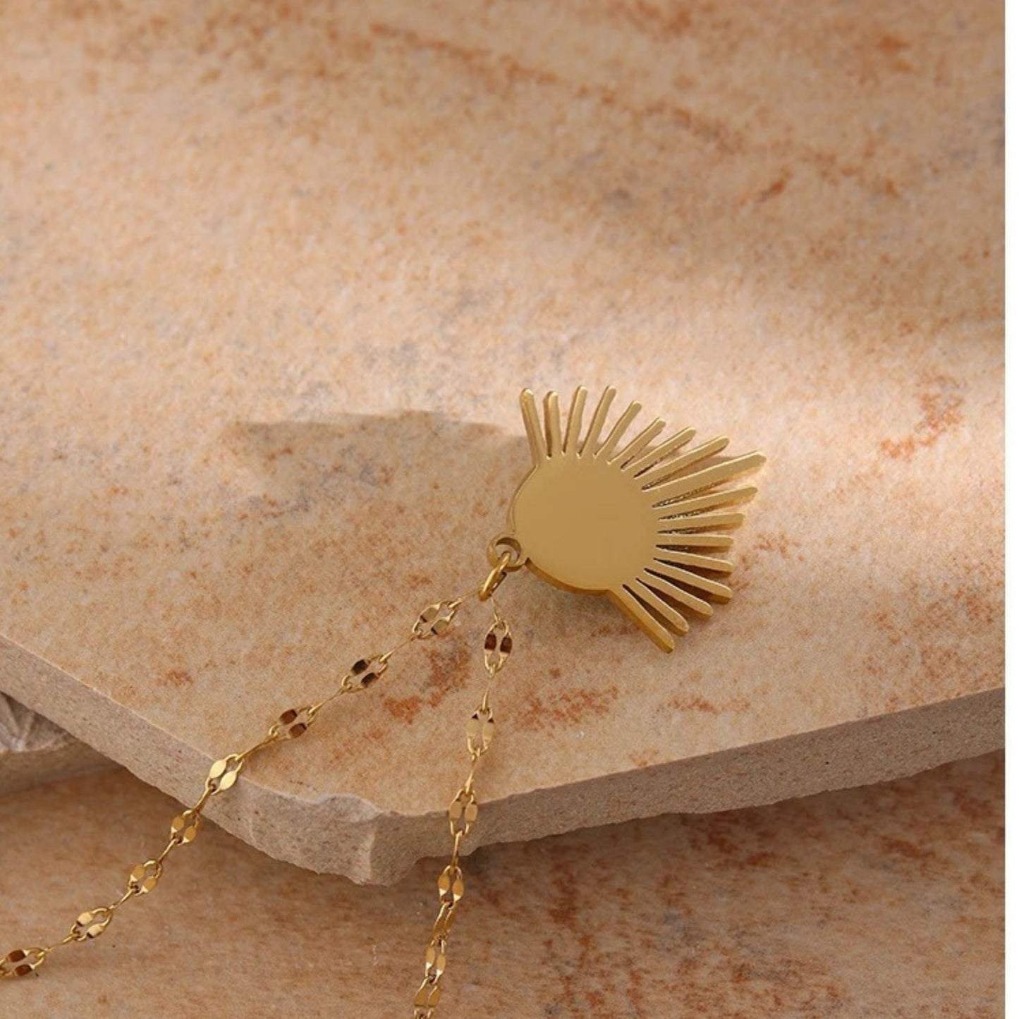 Close up showing the back of the Bohemian Radiance Necklace with a radiant 18K gold-plated pendant and natural turquoise stone, offering summer bohemian elegance.