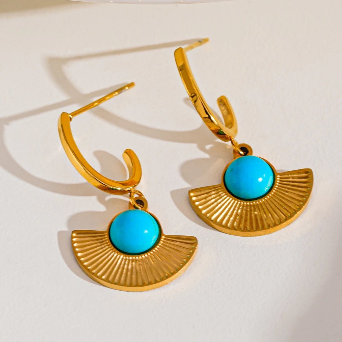 Bohemian Radiance Earrings with a fan-shaped design and natural turquoise stone set in 18K gold-plated stainless steel.