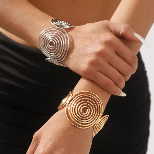 Bohemian Spiral Wire Cuff Bracelet styled on a wrist, highlighting its bold spiral wire design in luxurious gold.