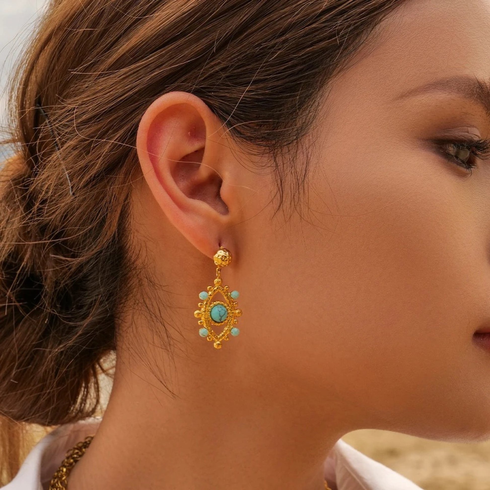 Bohemian Turquoise Medallion Earrings featuring intricate gold medallion design with vibrant turquoise stones.