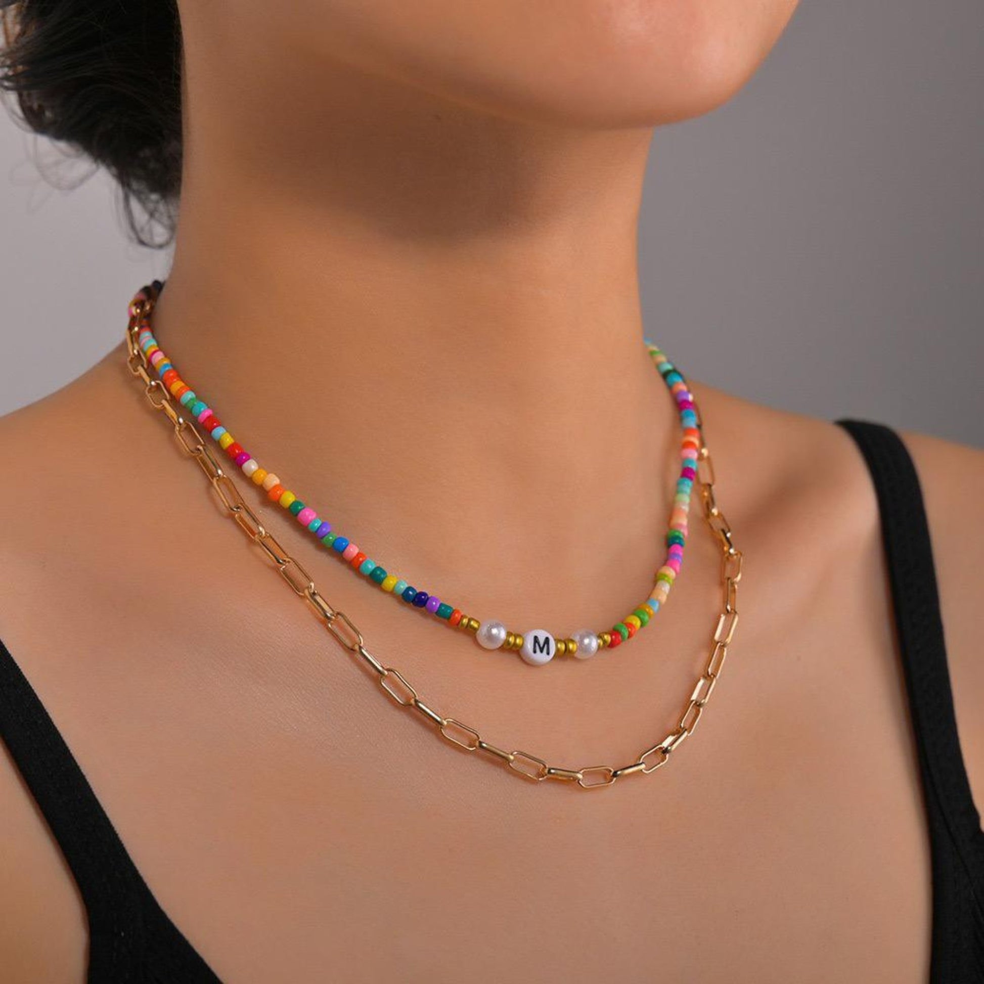 Boho Chic Layered Bead Necklace featuring colorful beads and 18K gold-plated chain for a playful yet elegant look.