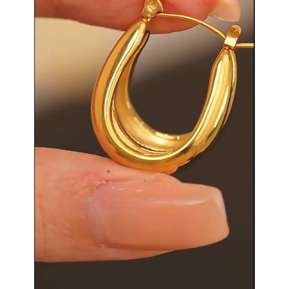 Bold Curved Hoops crafted from stainless steel with 18K PVD gold plating, featuring a sculptural design for modern elegance.