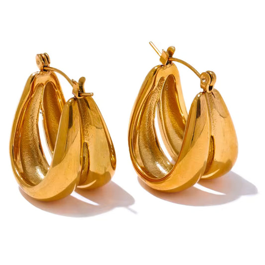 Close-up of Curved Gold Hoops showcasing sleek curved structure and polished gold finish.