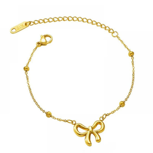 Close-up of Bow Anklet showcasing bow charm and fine gold chain for playful elegance.