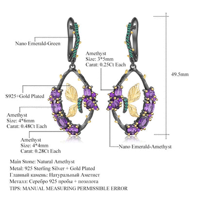 Detailed view of the amethyst stone in the Amethyst and Emerald Sterling Silver Earrings, featuring its rich purple hue and oval 3x5 mm shape.