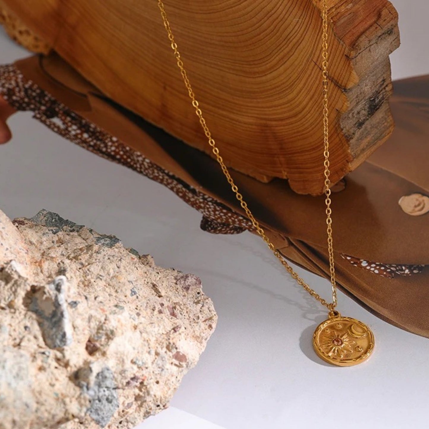Close-up of the Celestial Sun and Moon Pendant Necklace highlighting the intricate celestial motifs on the gold-plated pendant.