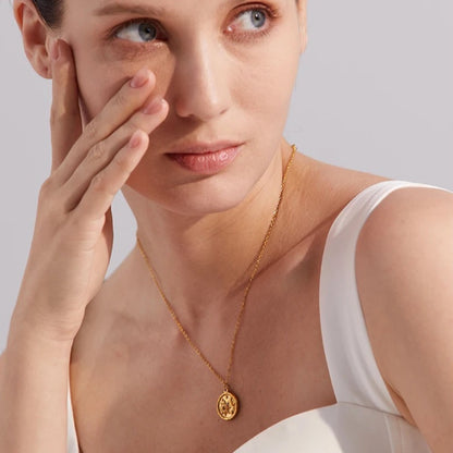 Celestial Sun and Moon Pendant Necklace styled on an elegant model, showcasing its elegant sun and moon design and 18K gold-plated finish.