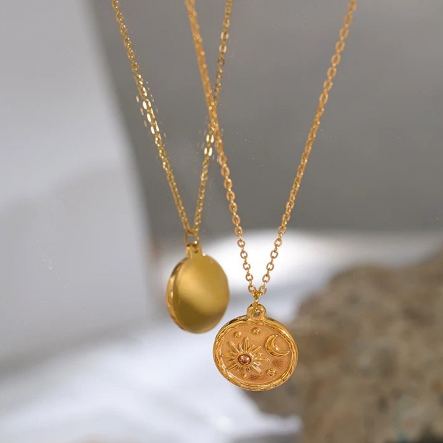 Close-up of the Celestial Sun and Moon Pendant Necklace highlighting the intricate celestial motifs on the gold-plated pendant.