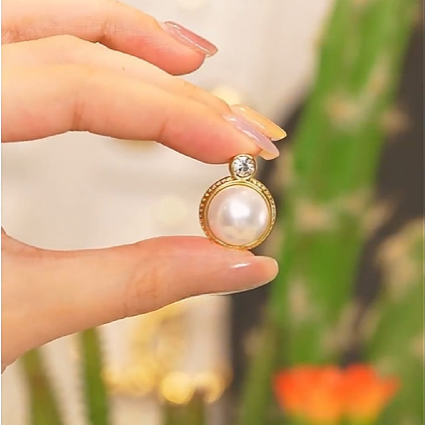 Close-up of the Classic Pearl & Zircon Stud Earrings highlighting the lustrous pearl and zircon gemstone in a detailed gold-plated frame.