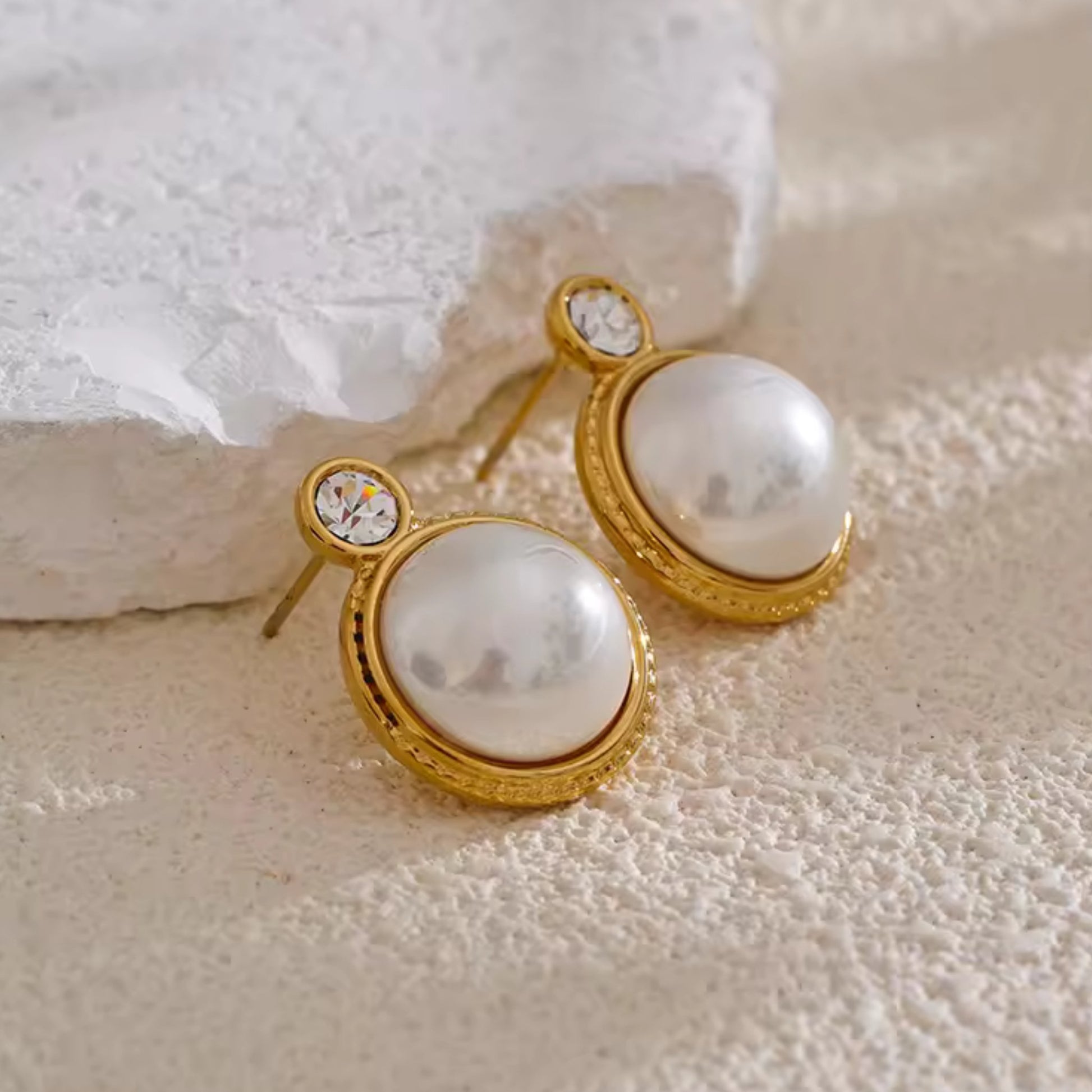 Side view of the Classic Pearl & Zircon Stud Earrings, showing the intricate gold-plated frame and durable stainless steel construction.