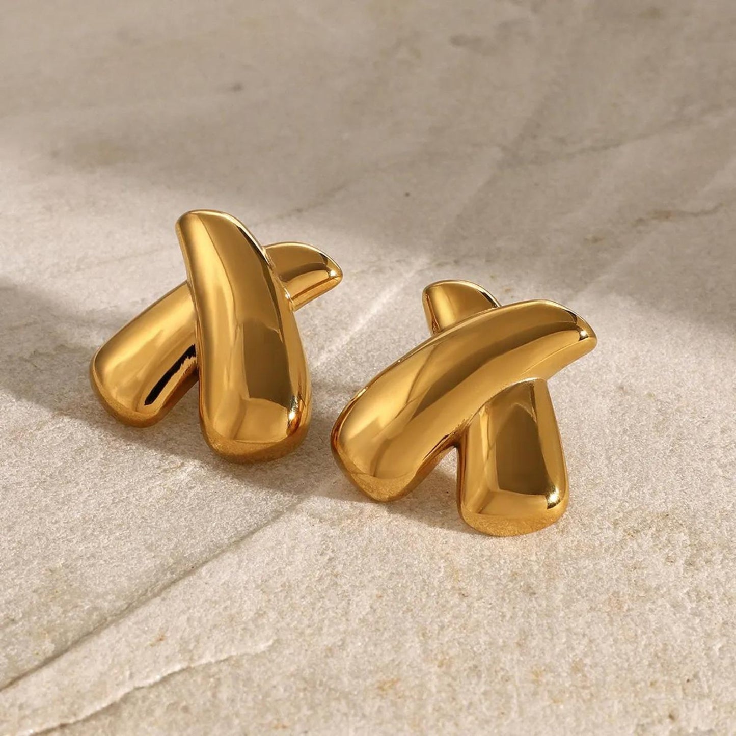 Crossed Elegance Gold Earrings in a bold Gold, perfect for adding a modern touch to any outfit.