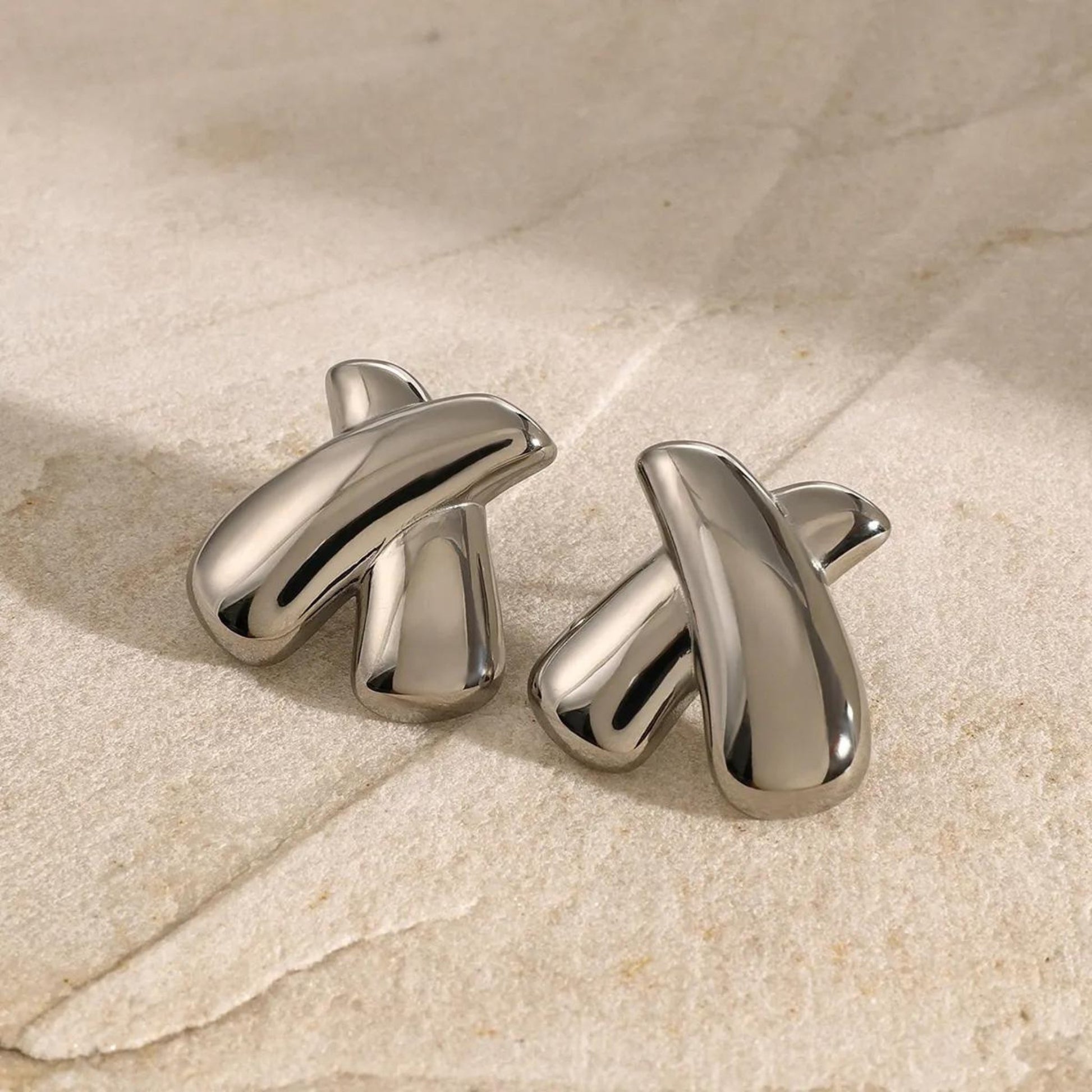 Crossed Elegance Silver Earrings in a bold Silver, perfect for adding a modern touch to any outfit.
