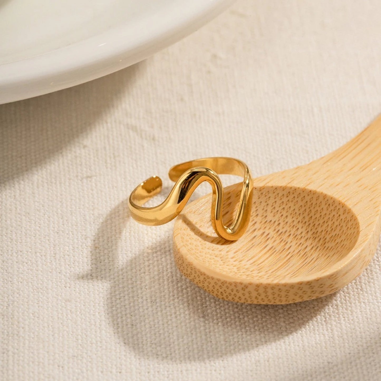 Close-up of the adjustable band on the Curved Arc Stacking Ring for a custom fit.
