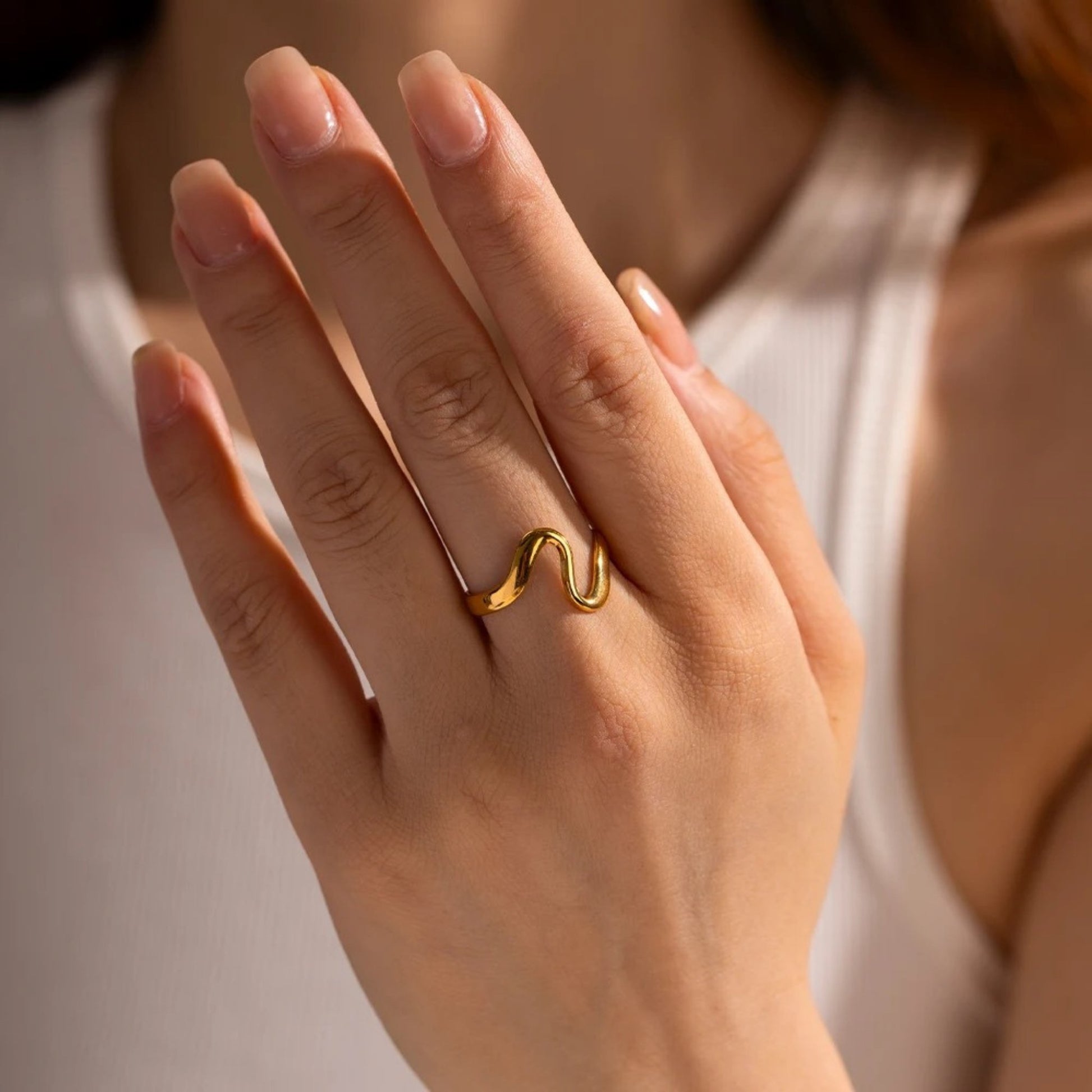 Stacked Curved Arc Rings styled on a model for a chic look.
