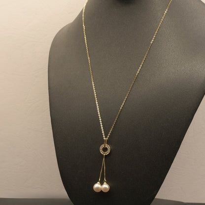 Dancing Pearls Necklace with freshwater pearls dangling from a zircon-adorned ring pendant.