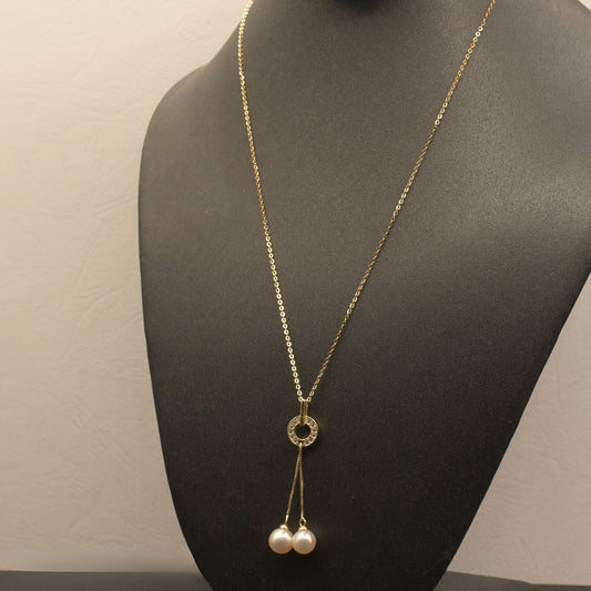 Dancing Pearls Necklace with freshwater pearls dangling from a zircon-adorned ring pendant.