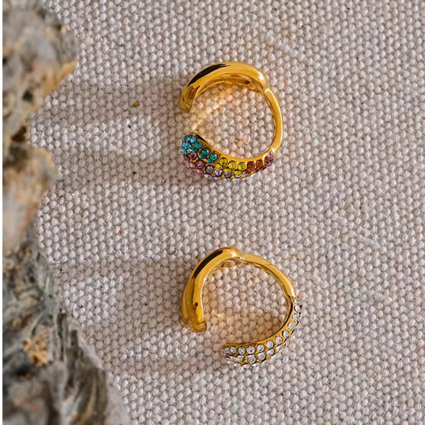 Close-up of the multicolored crystal curved ring and clear crystal twist design in the Dazzling Twist Ring Set.