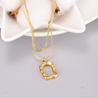 Close-up of the irregular rectangular pendant on the Dual Layer Necklace with 18K gold plating.