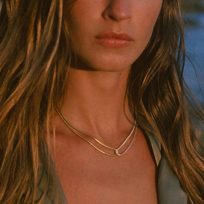 Close-up of the unique blade snake chain showcasing the dual-tone gold and silver sides styled on a model.