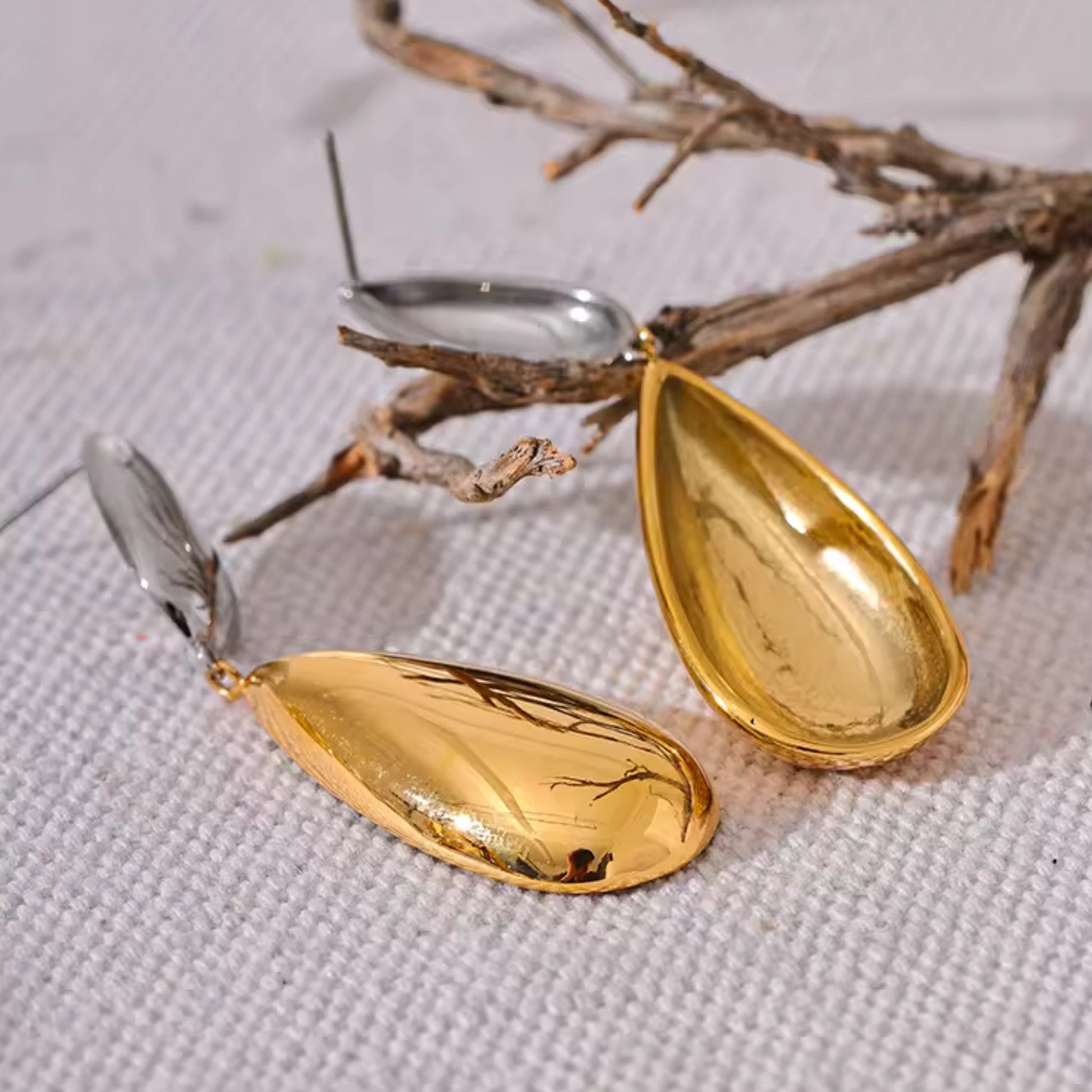Back-Side view of the Dual-Tone Drop Earrings, featuring a smooth and polished teardrop design.