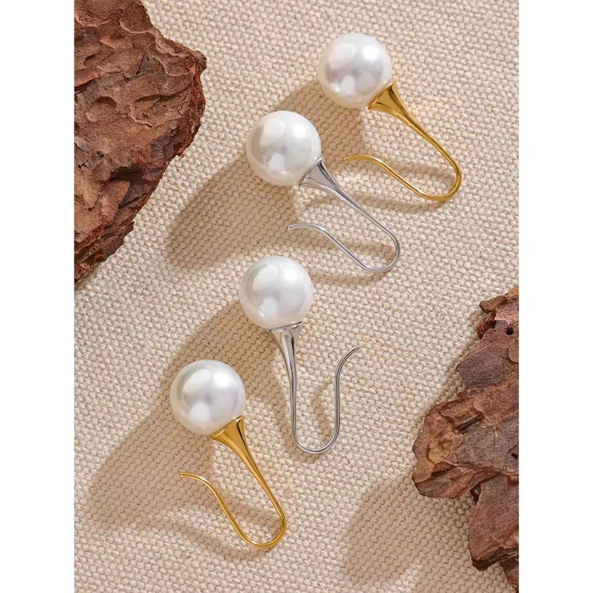 Flat-lay of Gold and Silver Elegance Pearl Drop Earrings, perfect for casual and formal occasions.
