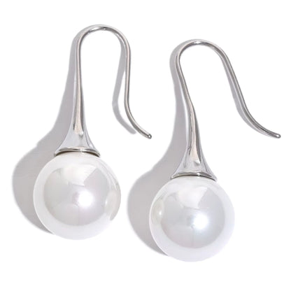 Silver-tone Elegance Pearl Drop Earrings showcasing their lightweight and modern design.