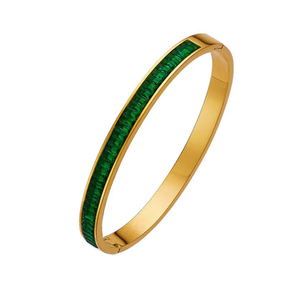 Close-up of Green CZ Bangle Bracelet showcasing intricate cubic zirconia detailing and radiant gold finish.