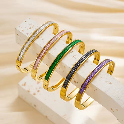 Flat-lay of all five color options: White, Pink, Purple, Green, and Black CZ Gold Plated Bangle Bracelets.