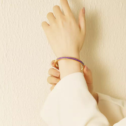 Model wearing a purple color 18K Gold Plated CZ Bangle Bracelets for a vibrant and chic look.