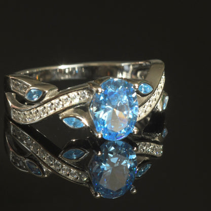 Close-up of Baby Blue CZ Sterling Silver Ring with platinum plating and sparkling side stones.