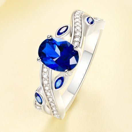 925 Sterling Silver Platinum-Plated Ring with a Dark Blue AAAAA Cubic Zirconia centerpiece and intricate CZ accents.