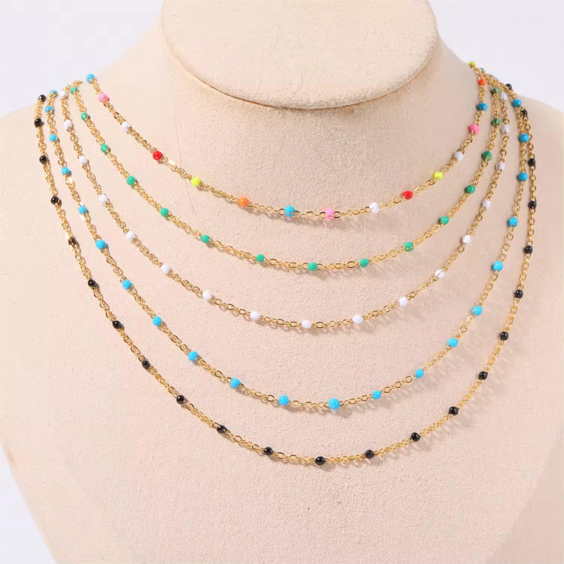 Flat-lay of all four bead options for the Elegant Cascade Necklace Collection: Black, Green, Sky Blue, and Colorful.