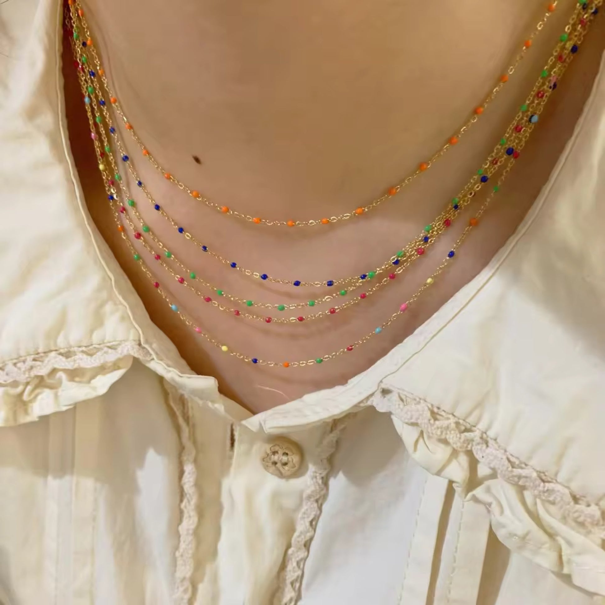 Model wearing all four bead options for the Elegant Cascade Necklace Collection: Black, Green, Sky Blue, and Colorful.