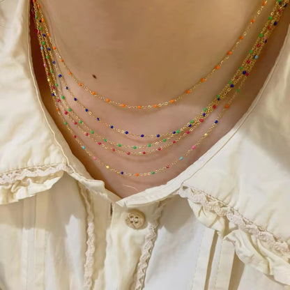 Model wearing all four bead options for the Elegant Cascade Necklace Collection: Black, Green, Sky Blue, and Colorful.
