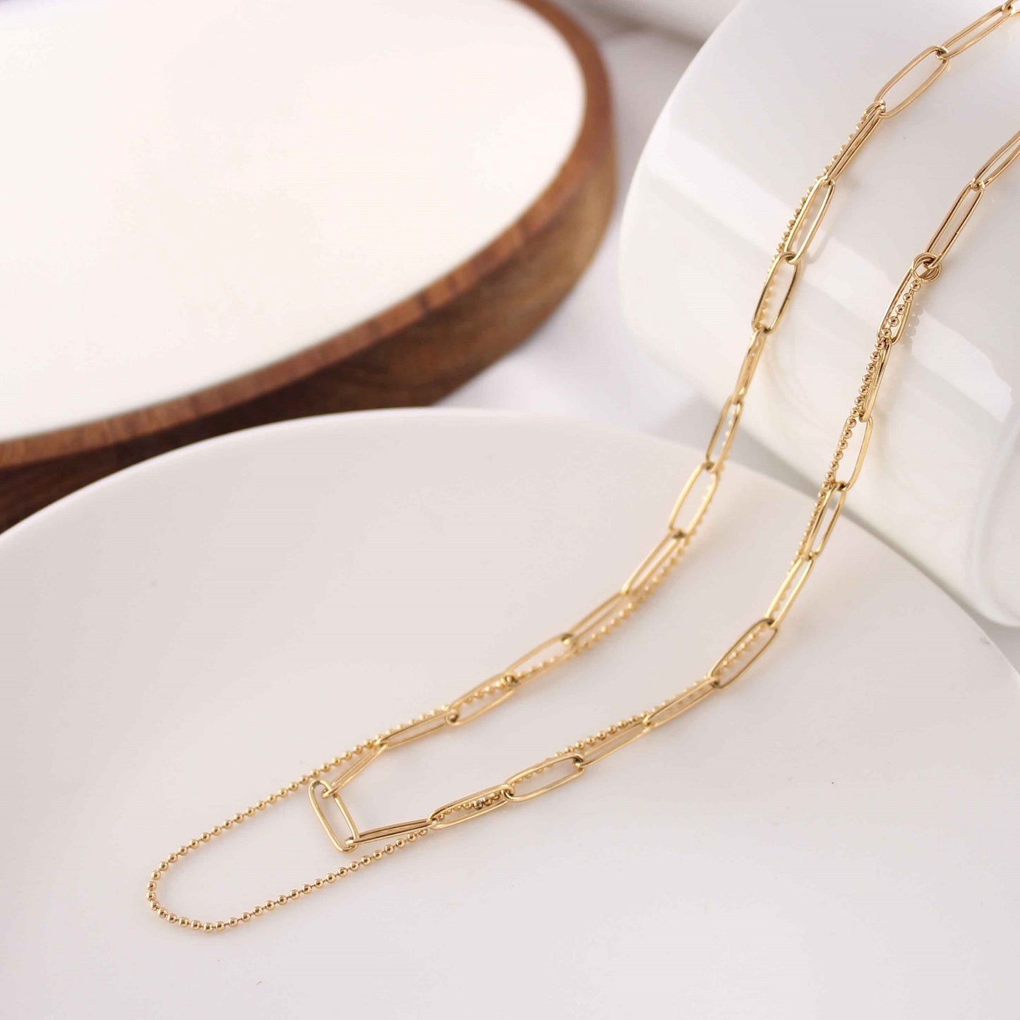 Elegant Double Layered Gold Plated Necklace with 18K gold finish displayed on a neutral background.