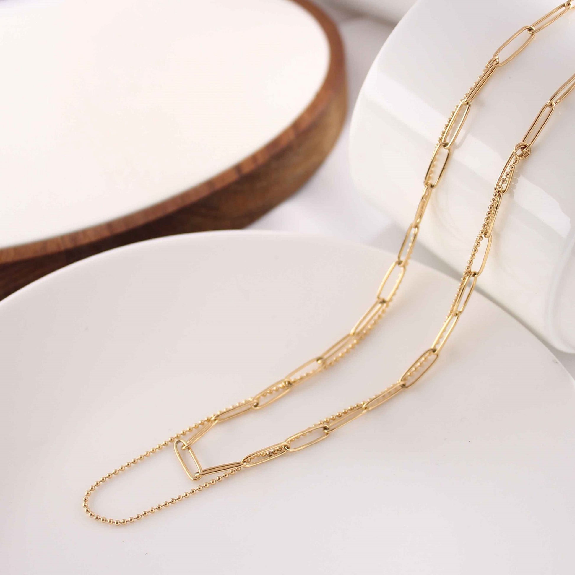 Elegant Double Layered Gold Plated Necklace with 18K gold finish displayed on a neutral background.