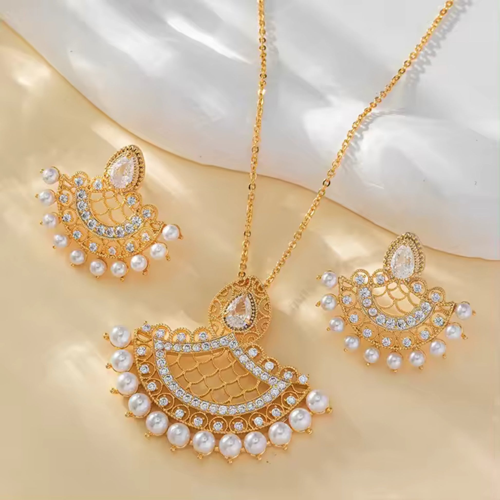 Fan-Shaped Pearl Necklace and Earring Set with 18K gold plating and lustrous pearls, displayed on a clean white background.