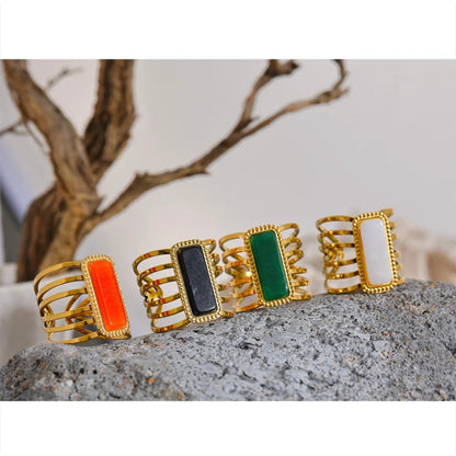 Close-up of the geometric hollow wide-open ring design in gold with a white stone, highlighting its modern elegance.